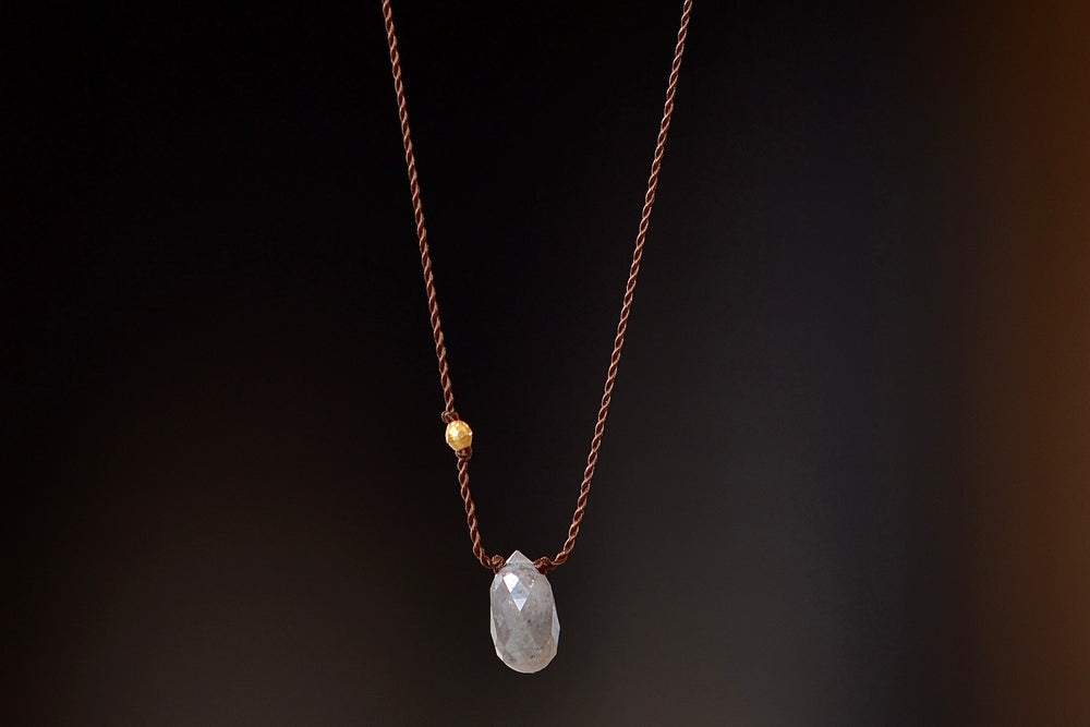 A raw and faceted gray diamond is accented with an 18k gold bead on poly nylon string to form this one of a kind organic necklace. Designed by Margaret Solow. 