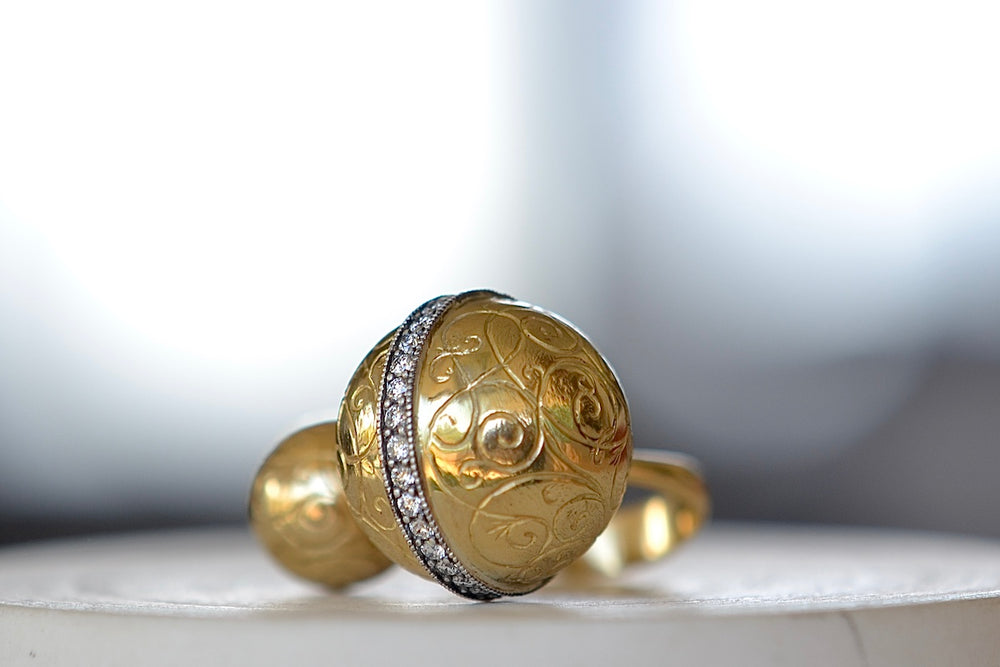 Duo Ball Ring by Arman Sakisyan is a double sphere ring with one larger and one smaller hollow and engraved ball on an open form and slightly tapered band. The larger sphere has a band of oxidized silver filled with 32 diamonds and filigree. Handmade in California.