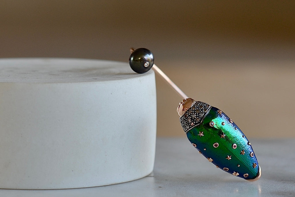 Scarab Pearl bangle by Bibi Van Der Velden is a bracelet bangle in 18k rose gold and sterling with  brown diamonds, a  scarab wing in amethyst  with pink sapphire, tsavorite and a Tahitian pearl.