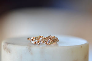 5mm Baguette Cluster Band band Suzanne Kalan is a ring made out of pronged white diamond baguettes in a fireworks setting on an 18k rose gold band. Size 6 in stock.