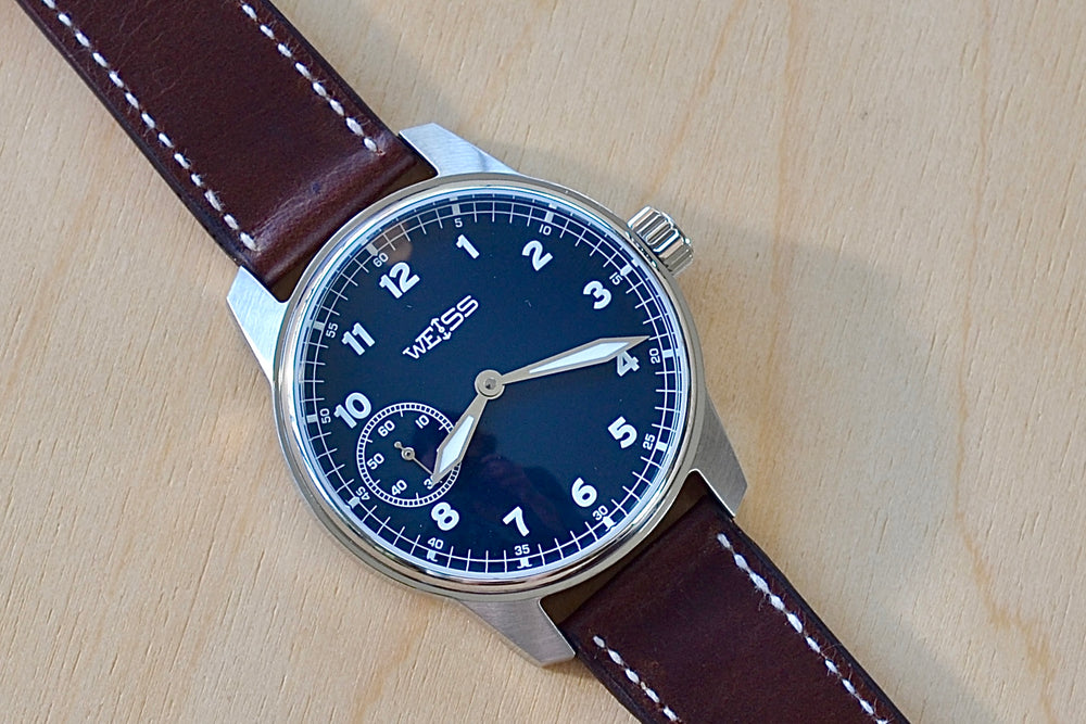 Weiss Watch 42mm Standard Field Watch with Navy Blue Dial, shown with brown Horween leather strap is manually wound, made with American parts, featuring Super Luminova hands and markers.