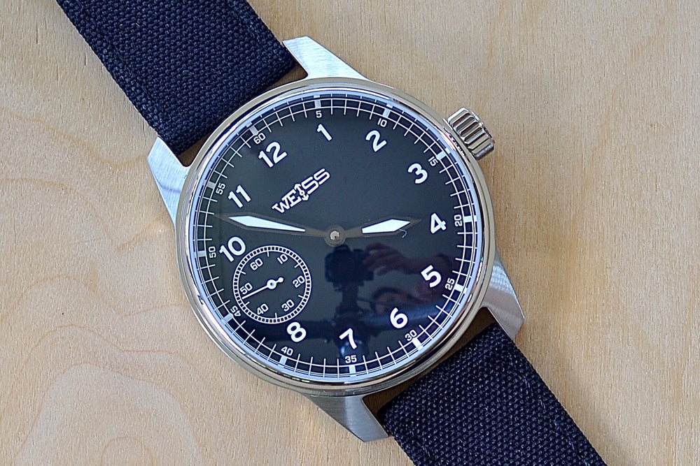 Weiss Watch 42mm Standard Field Watch with Black Dial, shown with black canvas strap is manually wound, made with American parts, featuring Super Luminova hands and markers.