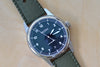 Weiss Watch 38mm Automatic Field Watch with Black Dial and date, shown with  olive rubber strap , made with American parts, featuring Super Luminova hands and markers. 