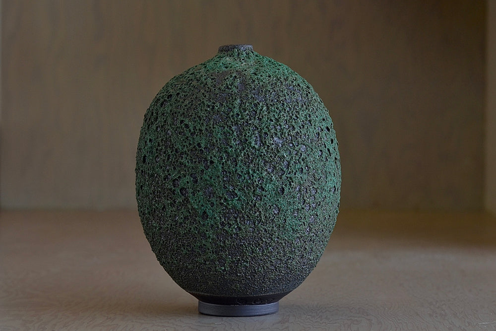 Heather Rosenman Tall Oval and Deep forest green Vase in volcanic glaze.