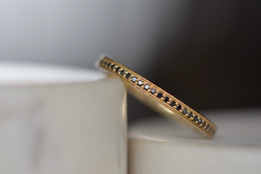 Black Diamond Stackable Eternity Band by Lizzie Mandler is a  one of a kind classic eternity band with beautiful black diamond pave and a white enamel edge inset  on top and bottom. Handcrafted in Los Angeles.