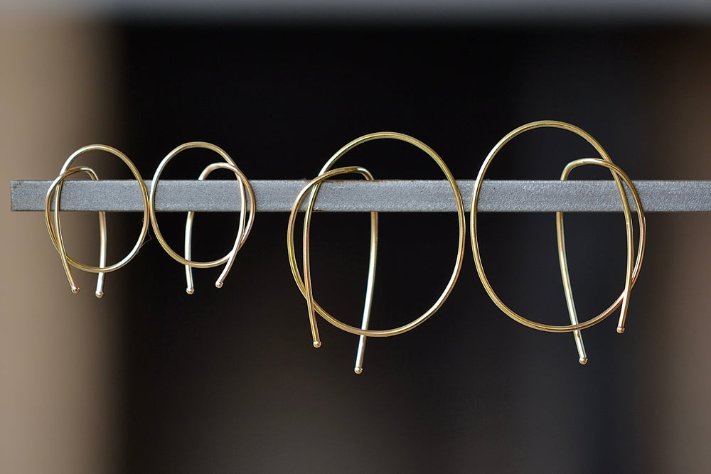 Kathleen Whitaker Rope earrings in small and medium. Gold wire is bent in a take on a classic hoop.