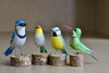 Selection of wooden and hand carved birds from Brazil, showing Blue Jay, Red Beak, Blue Tit and White Throated Hummingbird.