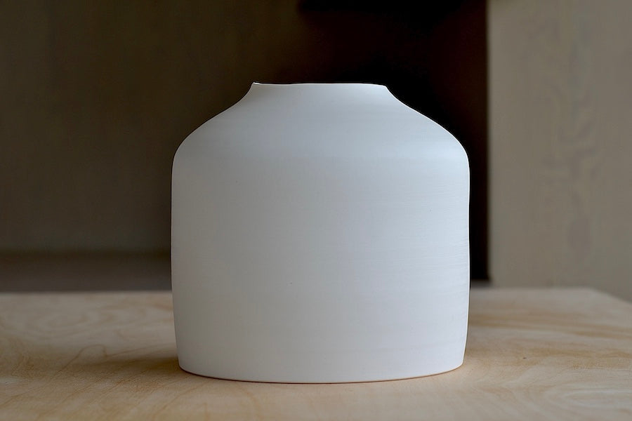 Lilith Rockett Urn Vase is wheel thrown porcelain with gloss glaze on the interior and an unglazed exterior.