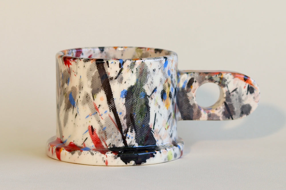 Black, red, blue and orange EXP splatter mug available at OK.