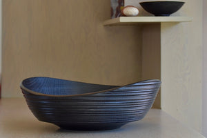 The Circle Factory Bowl in Black Oak with Ridges is a Large Circle turned wood bowl in Black Oak with ridged detail by George Peterson. Made in North Carolina. Food safe, but finish can be affected if in contact with anything acidic.