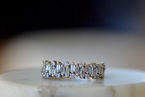 The Alternating Diamond Half Eternity Band is a sophisticated and modern half-eternity band with alternating round white diamonds and white diamond baguettes set on a gold band. The rounds are scattered throughout. Size 6 in stock. Handmade in Los Angeles. 