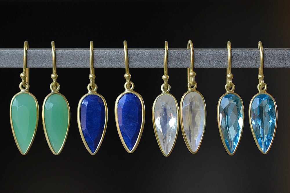 Medium Leaf Earrings by Tej Kothari are Lightly faceted and tear drop shaped stones set in 18k yellow gold with gold ear wire. Shown in Chrysoprase, Lapis Lazuli, Rainbow Moonstone and Blue Topaz.
