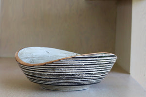 Circle Factory Painted Bowl 15x5.5 is a  turned wood bowl in Maple, painted black and white, with ridged grooves and stitch detailing by George Peterson. Made from salvaged wood in North Carolina and painted. Food safe, but finish can be affected if in contact with anything acidic.