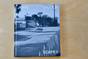 Scapes by John Diviola is a book From visual artist John Diviola comes this book of black and white photographs including&nbsp; "Four Landscapes," "As Far I Could Get," and&nbsp; "Dogs Chasing My Car in the Desert". Text by David Campany..&nbsp; Published by SkinnerBoox in an edition of 750. Rare and out of print.