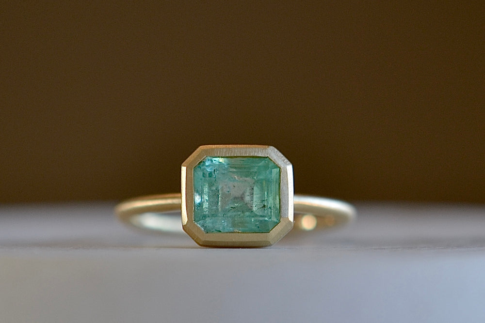 Simple emerald band ring by Elizabeth Street 23A is a 1.35 CT Columbian emerald in a 14k bezel and band.