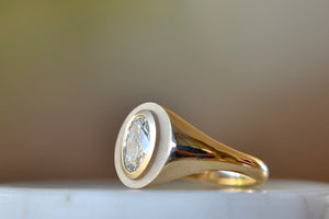 Oval Signet by Elizabeth Street Jewelry is a A bezel set oval lab grown diamond 1.08ct in flat top signet style on a tapered 14k yellow gold band VS2. Handmade in Los Angeles.