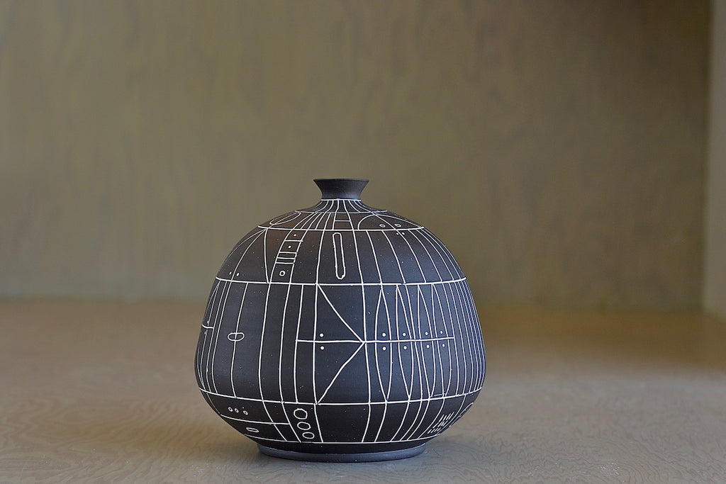 The HR 400 'Scribe" vase is a ceramic  hand thrown stoneware vase with sgraffito patterns by Heather Rosenman. 
