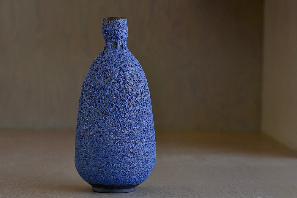 Tall Blue Bottle vase in volcanic glaze by Heather Rosenman.