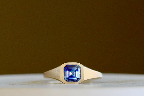 Ceylon Sapphire Signet by Elizabeth Street Jewelry is a one of a kind and near square petite signet comprised of a ceylon sapphire on a tapered band in 14k satin finish. Handmade in Los Angeles.