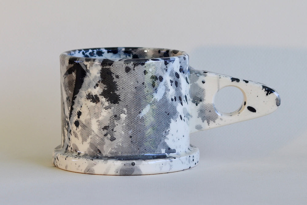 Gray and black EXP splatter mug available at OK.