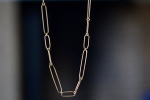 Long 14k gold paperclip chain with two short, one long flat clips in 17 inches by Kaylin Hertel.