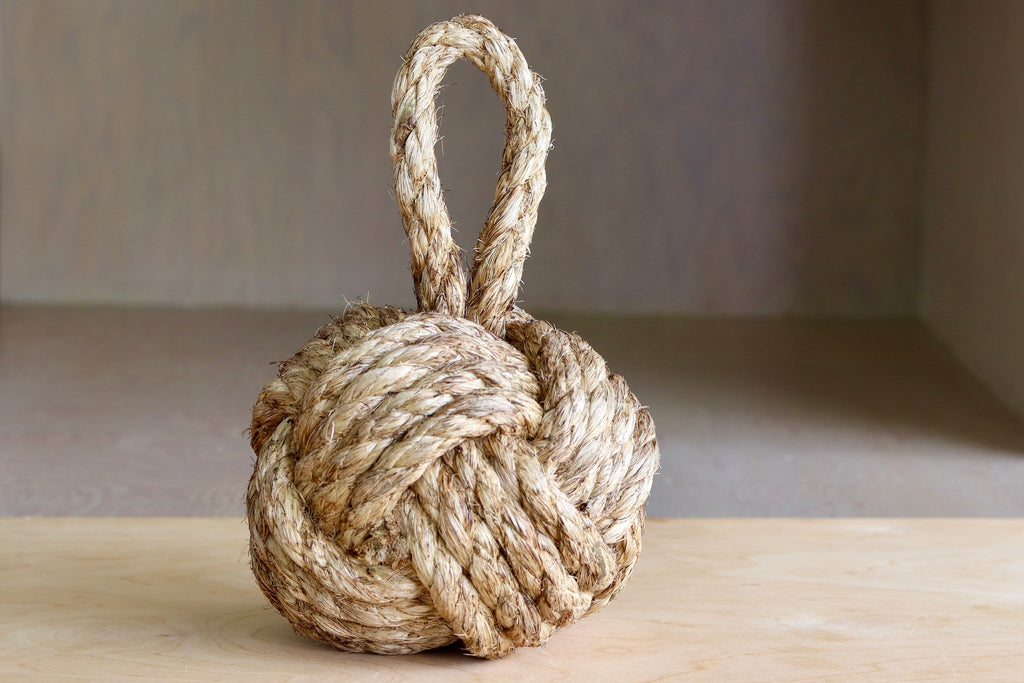 Knot door stop made out of rope.