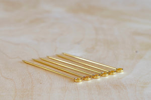 Alternate view of a set of six gold circle and gold plated cocktail picks made in Japan.