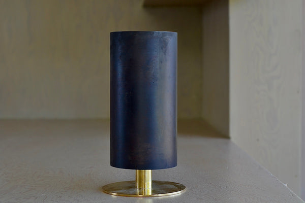 The Aubock Vase on Pedestal in Large 7247-6 is a thin rimmed patinated brass tube vase with polished base in large designed by Carl Auböck.