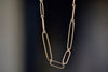 Short 14k gold paperclip chain with two short, one long flat clips in 15 inches by Kaylin Hertel.