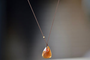 Hessonite and Sapphire Pendant Necklace designed by Margaret Solow is a A faceted Hessonite stone slice accompanied by a smaller orange and faceted sapphire slice of which the smaller is set in 18k gold with with a gold bead on the string makes this one of a kind organic pendant necklace.