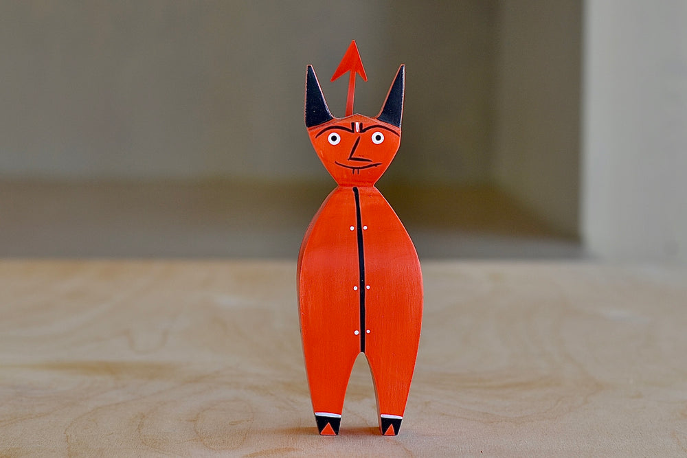 The Wooden Little Devil is a bright red decorative figurine that is part of the Alexander Girard doll collection. Hand painted and priduced by Vitra. 