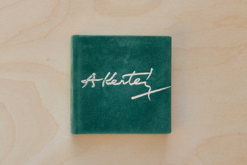 A rare and out of print Andre Kertesz miniature photo book bound in green velvet with gilt lettering that was published by  Szentendre in 1987 with text in Hungarian, German, English and French.