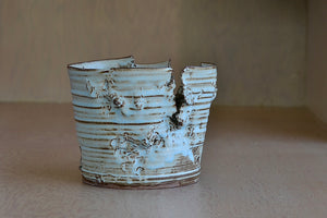 The Hyejeong Kim Torn Vase 15 is a  ceramic cylindrical torn vase by Hyejeong Kim, a Korean potter currently working in Seoul and trained in both Japan and Britain, combines these three important ceramic art traditions. Handt hrown porcelain with blue celadon glaze. Hyejeong was a Loewe Craft Prize 2020 finalist.