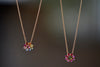 Daisy Necklace by Polly Wales in two color ways. A floral cluster made out of a center cabochon and a row of encrusted and inverted brilliant marquise sapphires in green and pink or pink and rainbow hangs on a beautiful 18k yellow chain. Recycled gold. Cast in Place. Cast not set. 