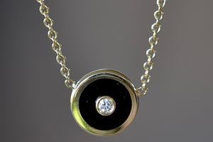 Mini Compass Pendant Necklace in Black Onyx by Retrouvai with round white diamond accent on 16" 14k yellow gold chain.