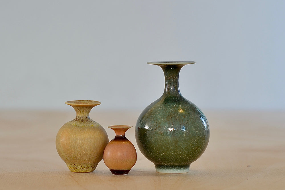 Miniature Hand Thrown Ceramic Vase Trio in Green, Ochre and Orange by Yuta Segawa on white background..