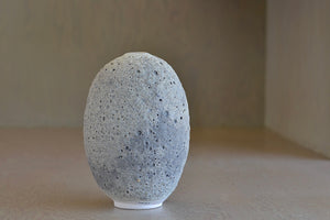 Other angle of Heather Rosenman oval ceramic vase in gray to white volcanic glaze.