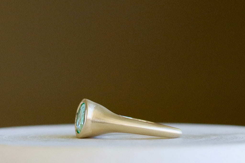 Side view of Colombian Emerald Signet with knife edge finish band by Elizabeth Street Jewelry.