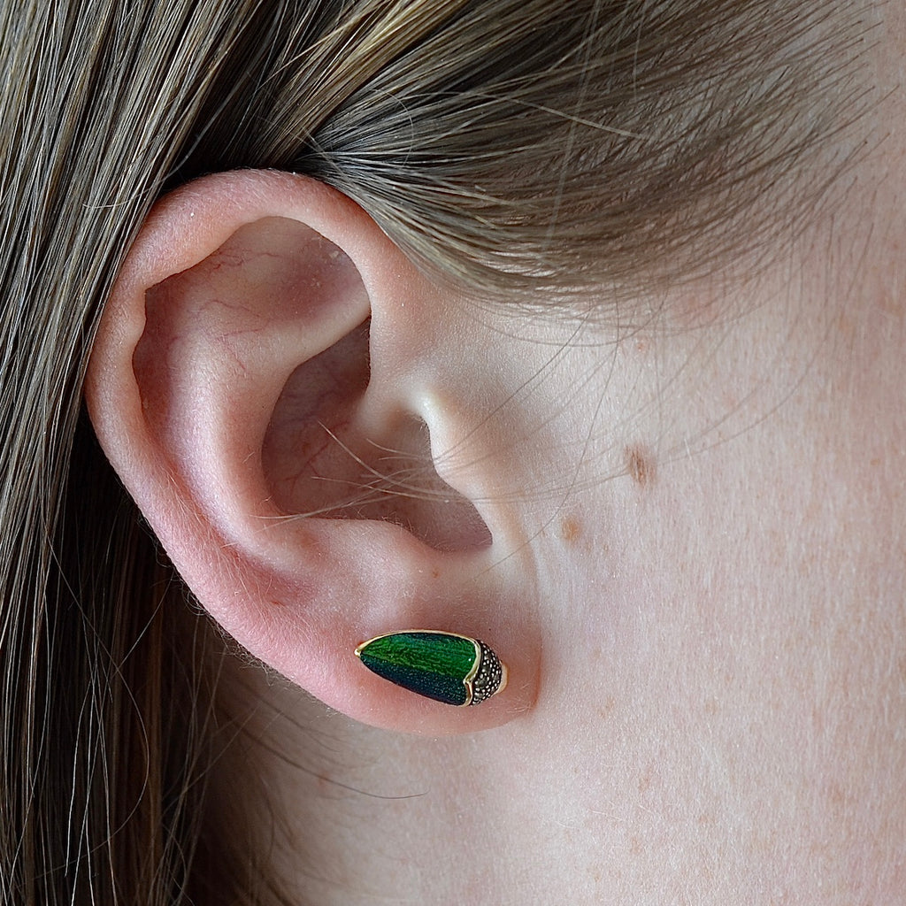 Wearing the Scarab stud earring by Bibi Van Der Velden in scarab wing.