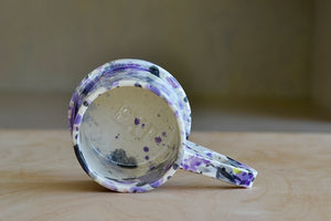 Interior view of EXP standard splatter mug in purple and black by Peter Shire and Echo Park Pottery..