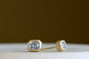 Bezel Set Asymmetrical Studs (earrings) by Elizabeth  Street Jewelry lying flat.