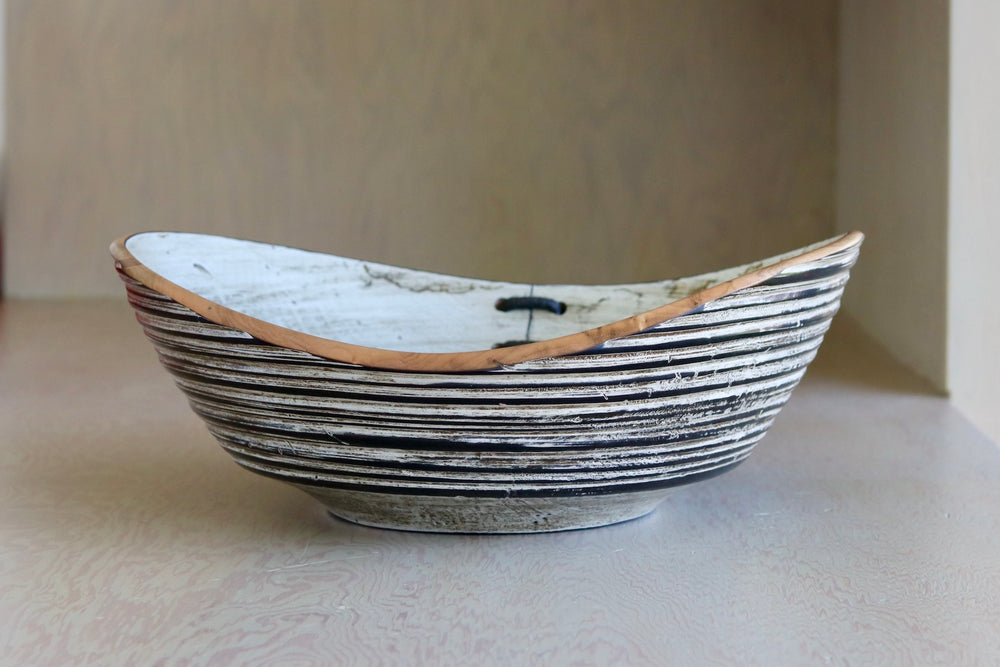 Another angle of Circle Factory Black and white bowl with mending.