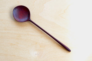 Hand carved wooden spoon up close.
