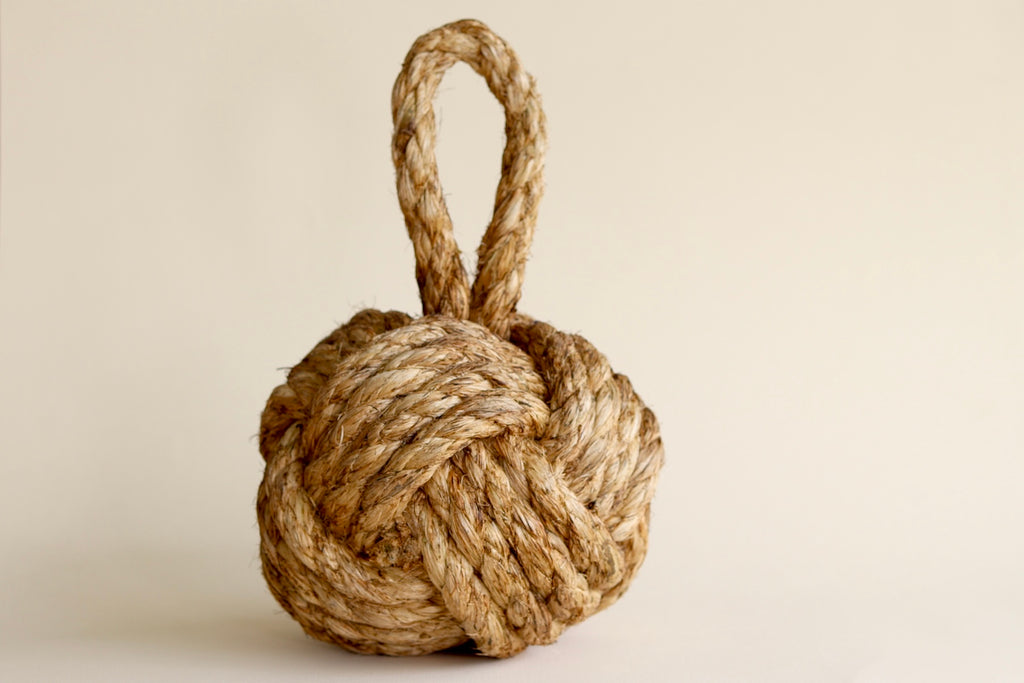 Knot door stop made out of rope.
