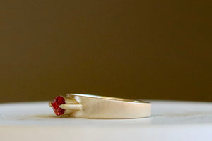 Side view of slim ciagar band with orange bi-color sapphire by Elizabeth Street Jewelry.