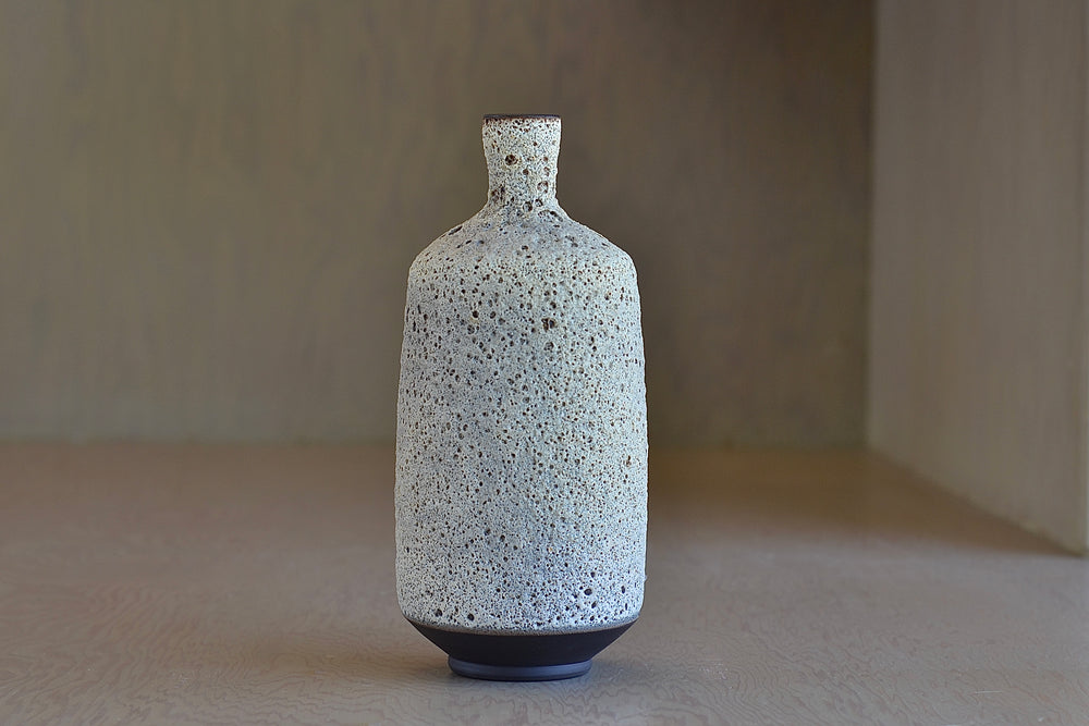 Other angle of Heather Rosenman Tall Gray to White Volcanic glaze ceramic vase.