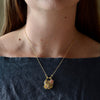 Wearing the Double Daisy Cluster Padlock Necklace by Polly Wales. 