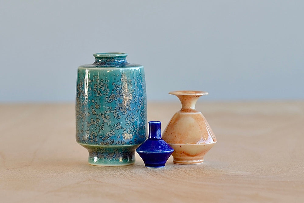 Miniature Hand Thrown Ceramic Vase Trio "C" in Green, Peach and Navy by Yuta Segawa on White background.