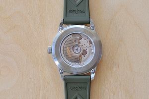 Back of Weiss Watch 38mm Automatic Field Watch with White Dial and date, shown with olive rubber strap , made with American parts. 