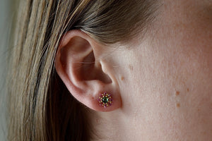 Wearing the green and pink Daisy stud earring by Polly Wales.